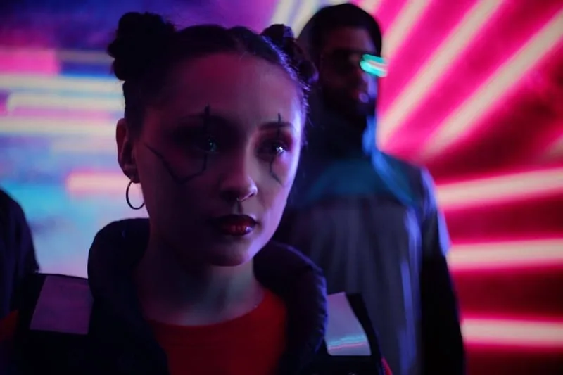Two characters under pink neon