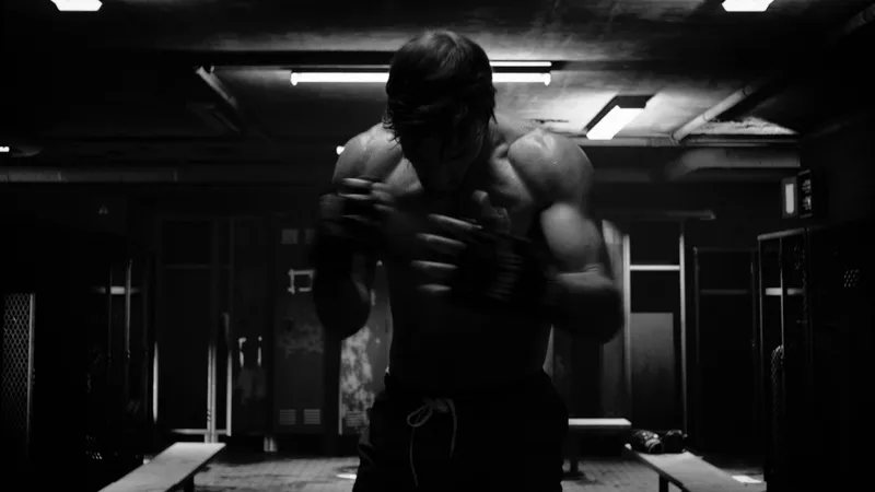 A boxer shadowboxing in a gym, in black and white